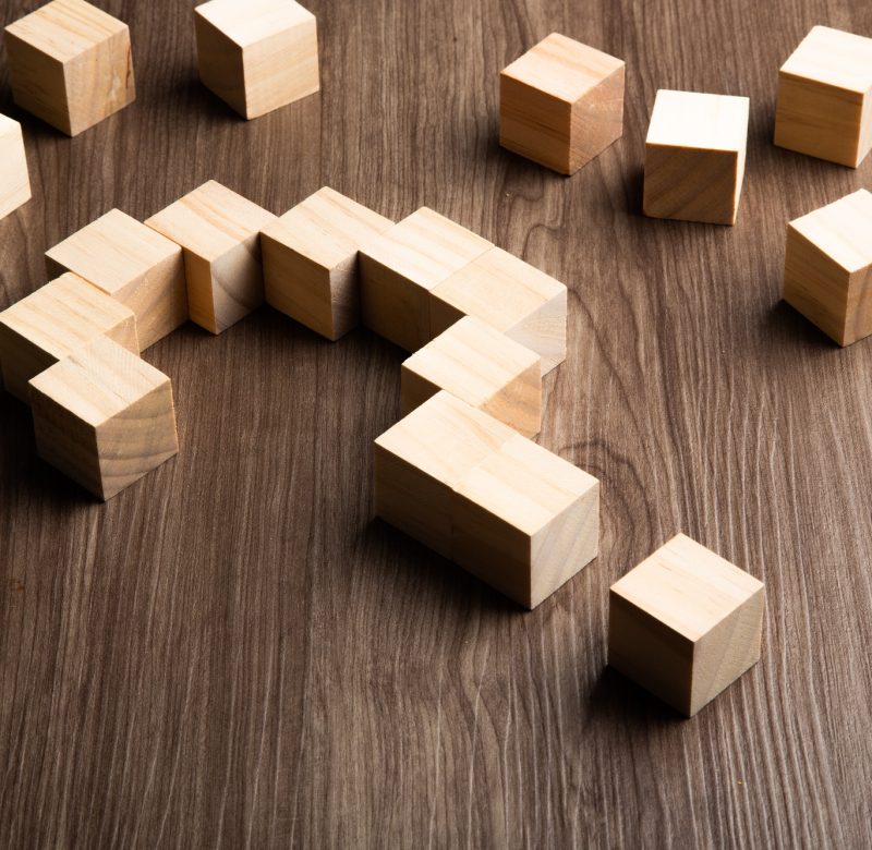 Forming bigger question mark. question mark on wooden table background